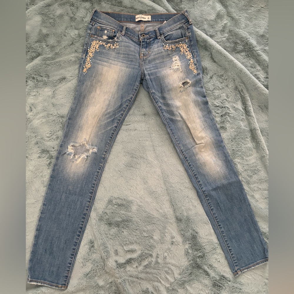 Light wash jeans with light floral/rhinestone details